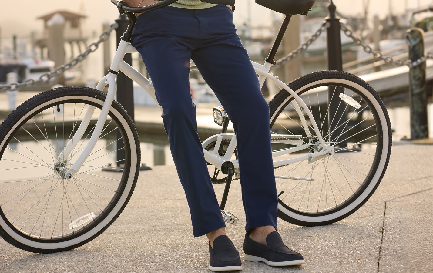 Man in navy pants and loafers with a bicycle