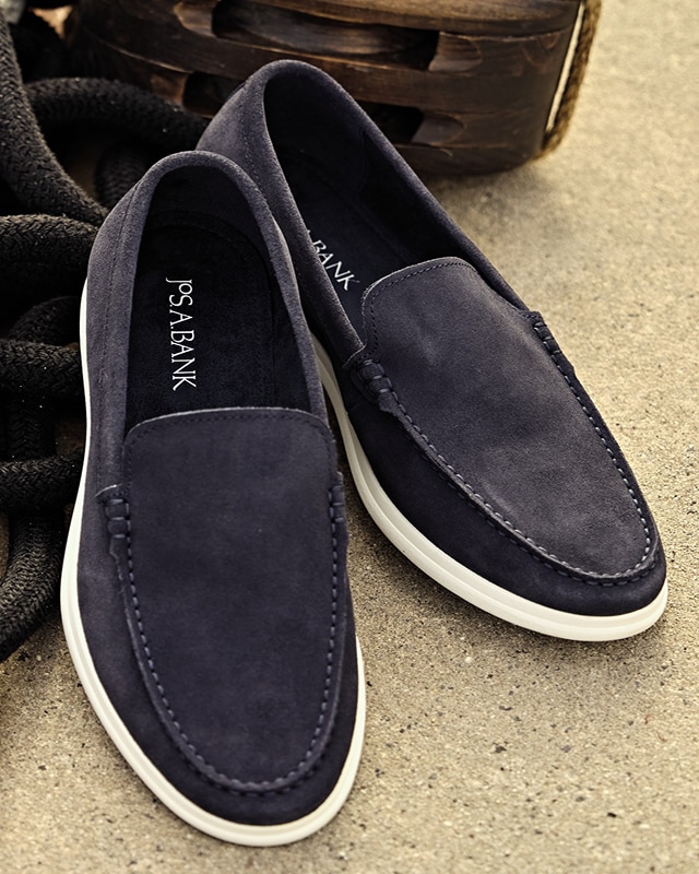 Navy blue suede loafers with white soles