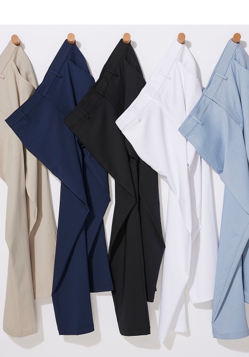 Four pairs of dress pants hanging on a rack