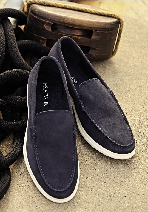 Navy blue suede loafers with white soles