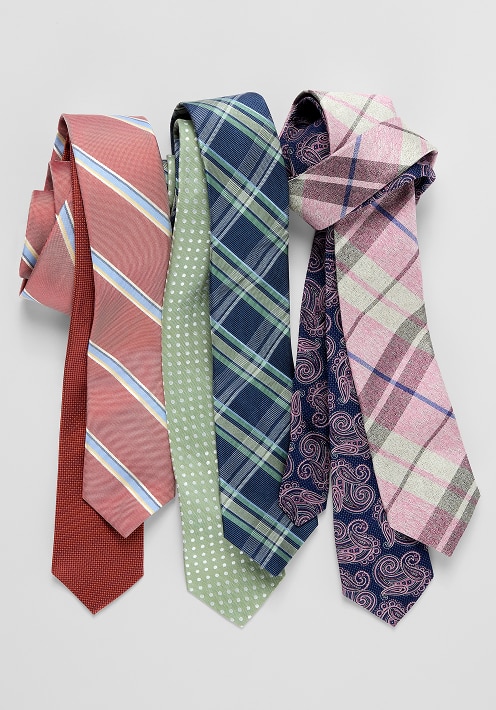 Five patterned ties in red, green, navy, and pink