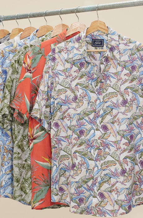 Tropical print short-sleeve shirts on a clothing rack