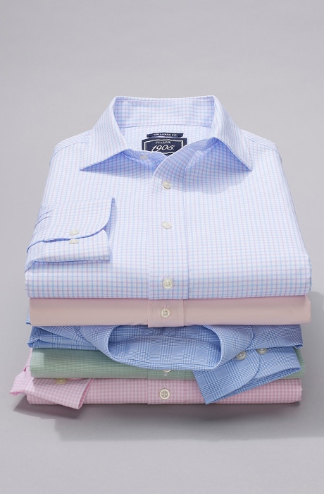 Stack of folded 1905 dress shirts in pastel colors