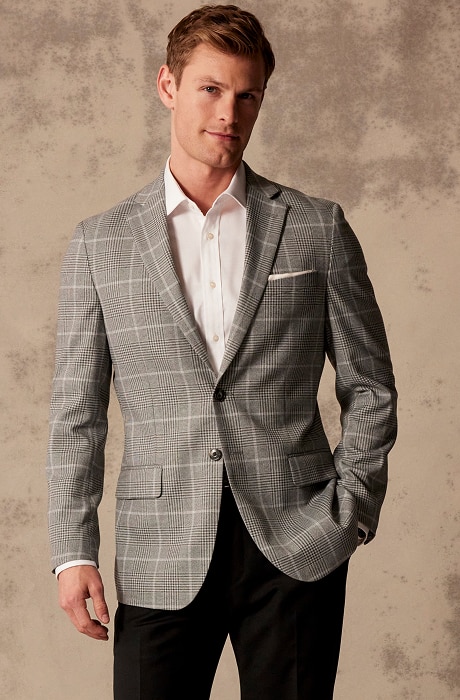 Man wearing a grey plaid sportcoat and white dress shirt