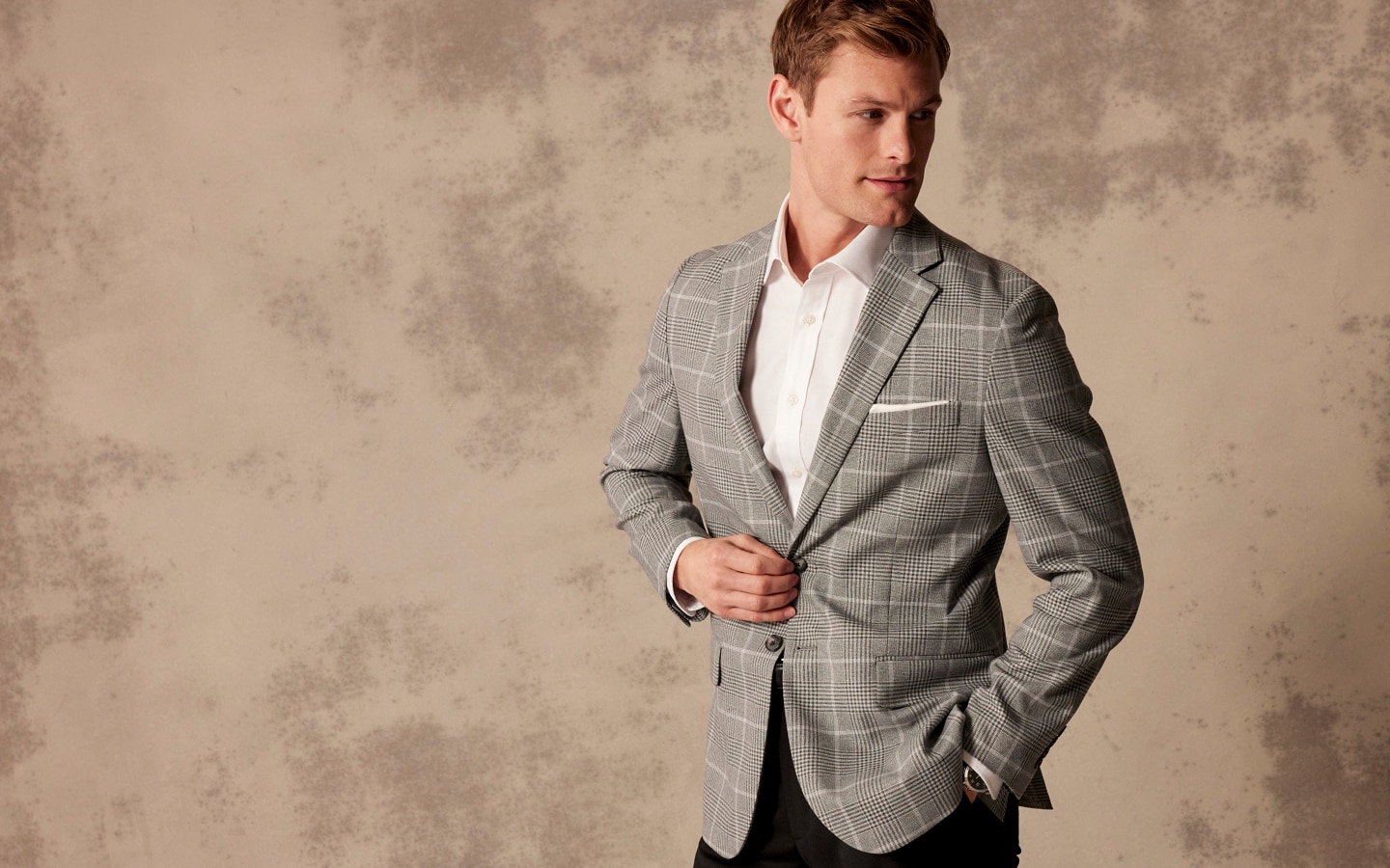 Man in grey plaid sportcoat and white dress shirt