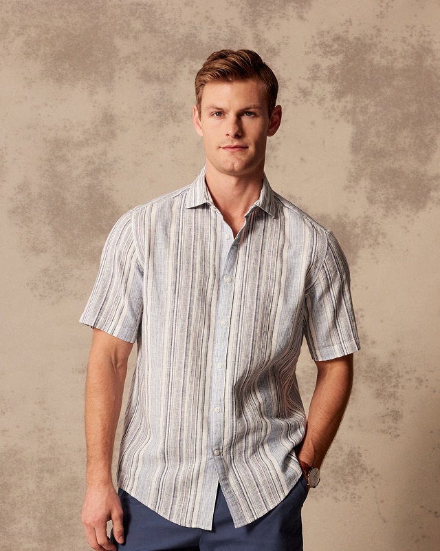 Man in a blue and white striped short-sleeve casual shirt