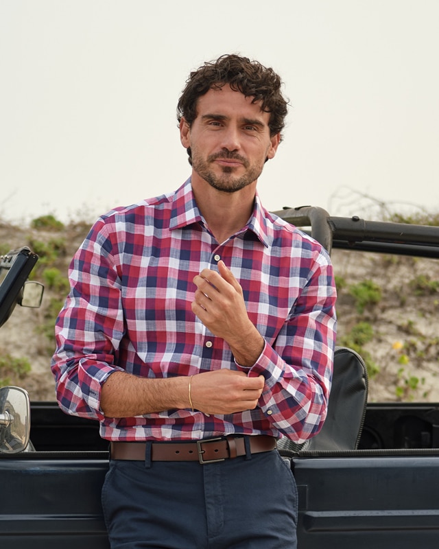 Man in a red and navy plaid long-sleeve casual shirt