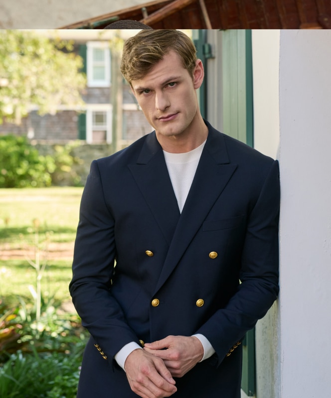 Man in navy double-breasted blazer with gold buttons