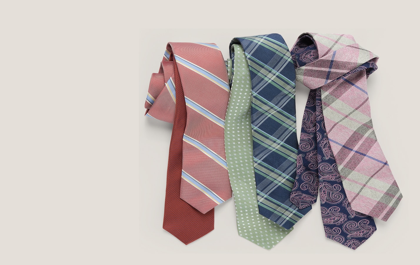 Patterned neckties in red, green, navy, and pink on a tan background
