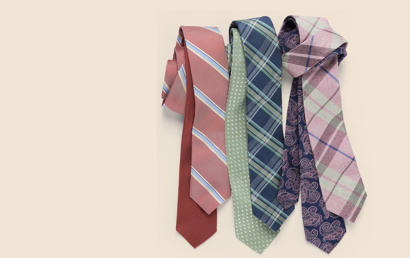 Collection of patterned mens neckties on a beige background