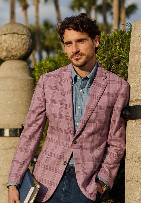 Man wearing a light purple plaid sportcoat over a blue chambray shirt
