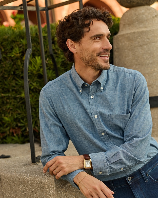Man wearing a blue casual button-down shirt outdoors