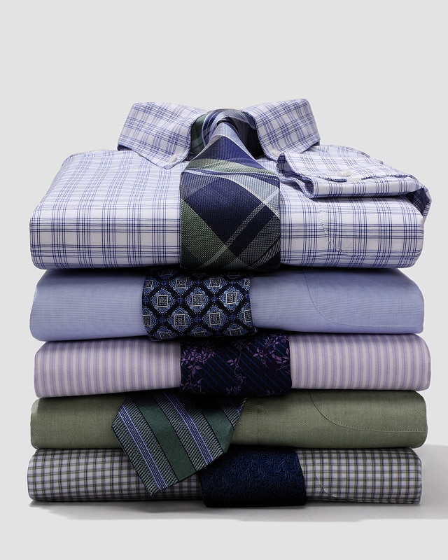 Stack of folded dress shirts with coordinating neckties