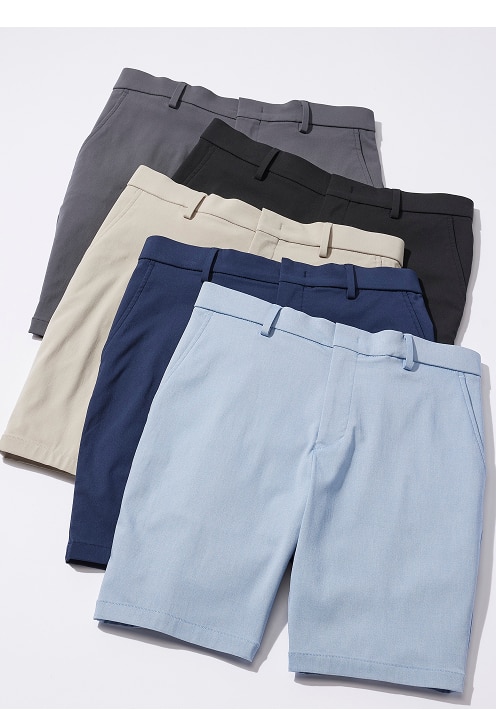 Stack of flat-front chino shorts in charcoal, black, khaki, navy, and light blue