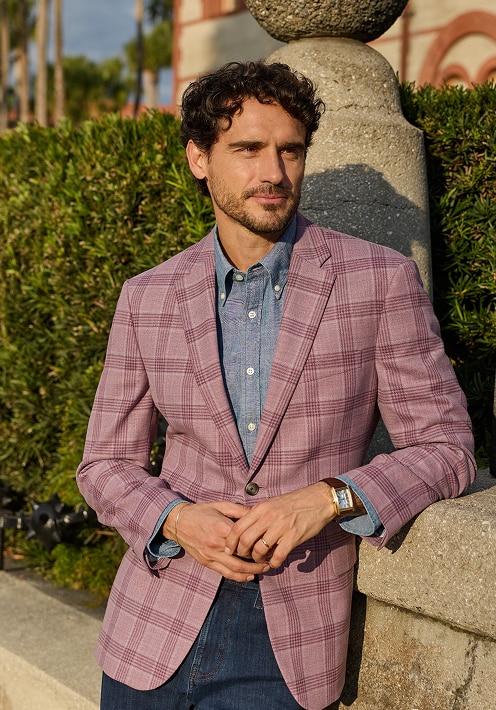 Man wearing a lavender plaid sportcoat over a light blue chambray shirt