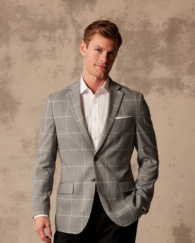 Man wearing a grey patterned sportcoat over a white dress shirt