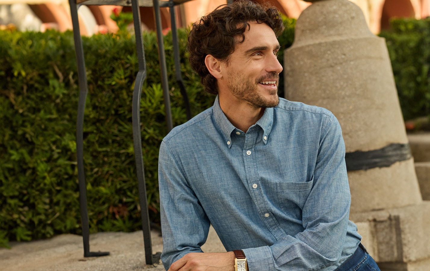 Man in a light blue casual button-down shirt outdoors