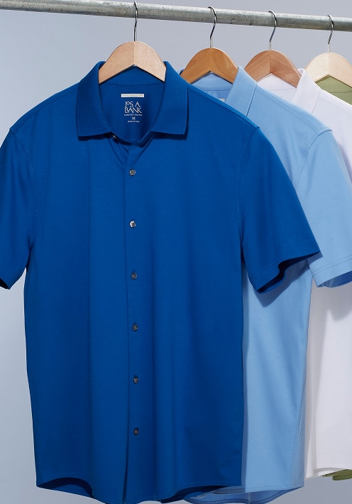 Blue, light blue, white, and olive short-sleeve casual shirts hanging on a metal rail