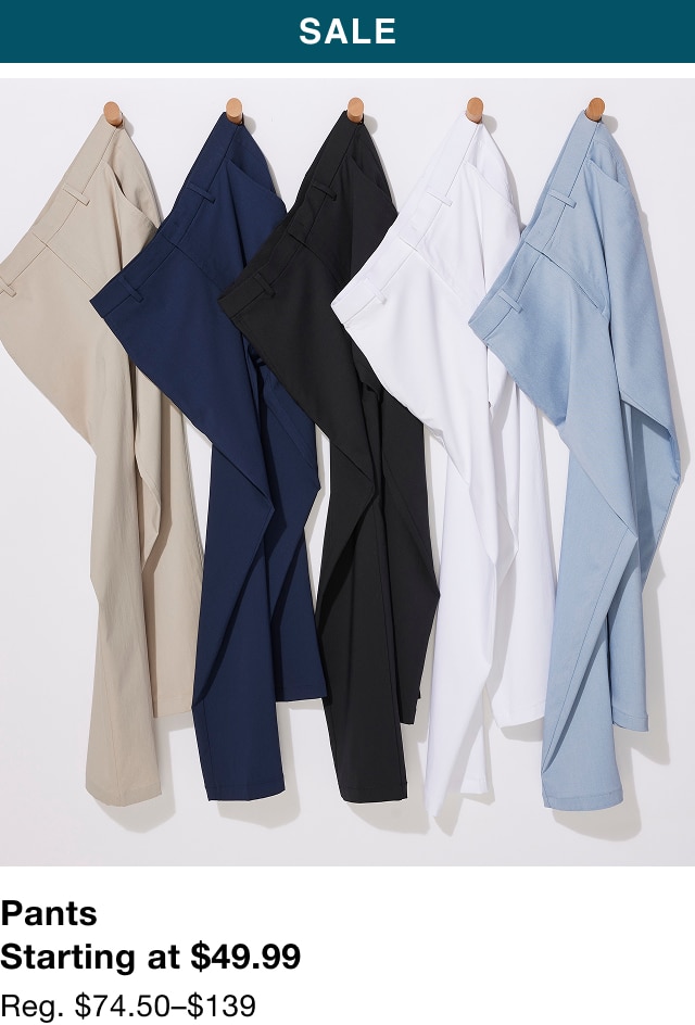 Five pairs of casual pants hanging on wooden pegs