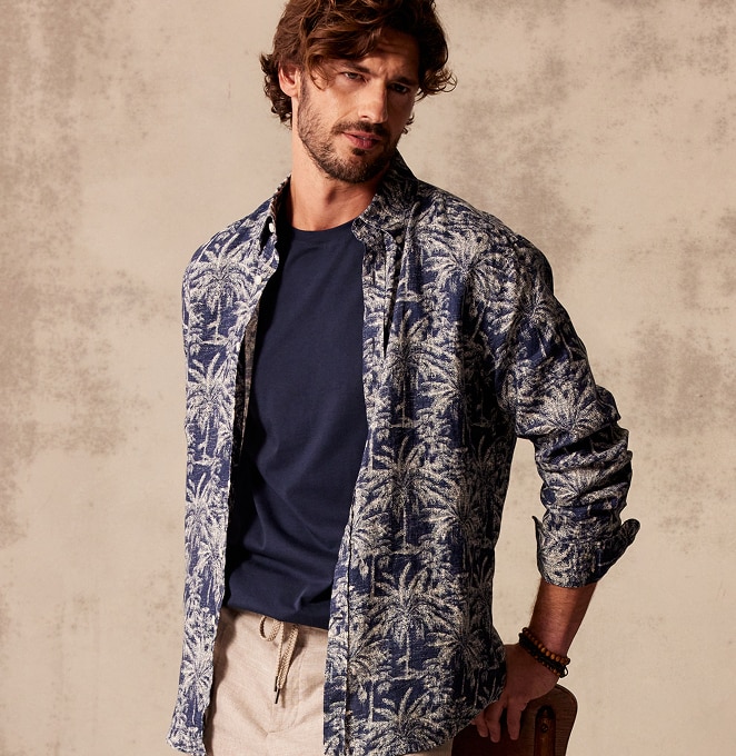 Man wearing a casual button-down shirt and polo