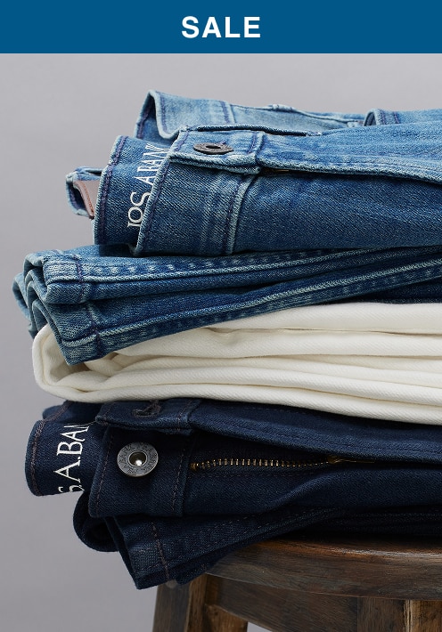 Stack of folded denim and chino pants