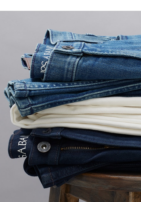 Stack of folded denim and chino pants