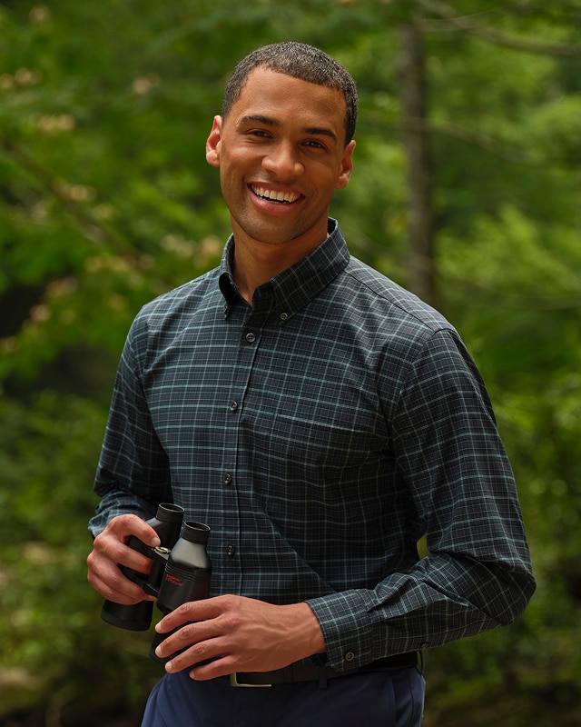 Man wearing a dark green plaid casual shirt