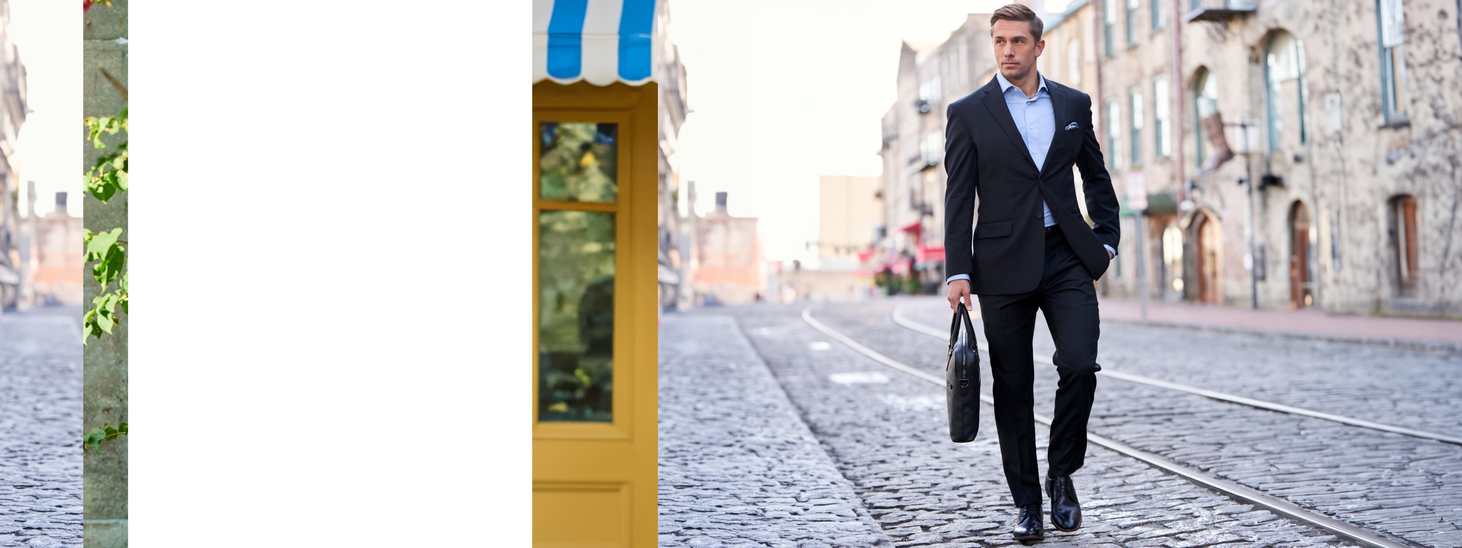 Man in a navy suit carrying a briefcase while walking down a cobblestone street