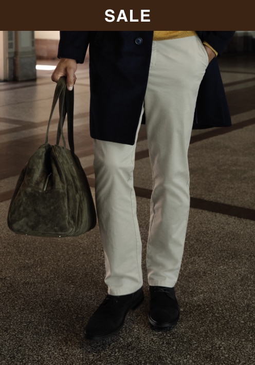 Sale. Man wearing khaki pants and a polo