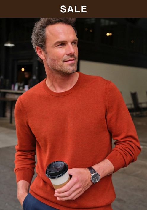 Sale. Man wearing an orange sweater