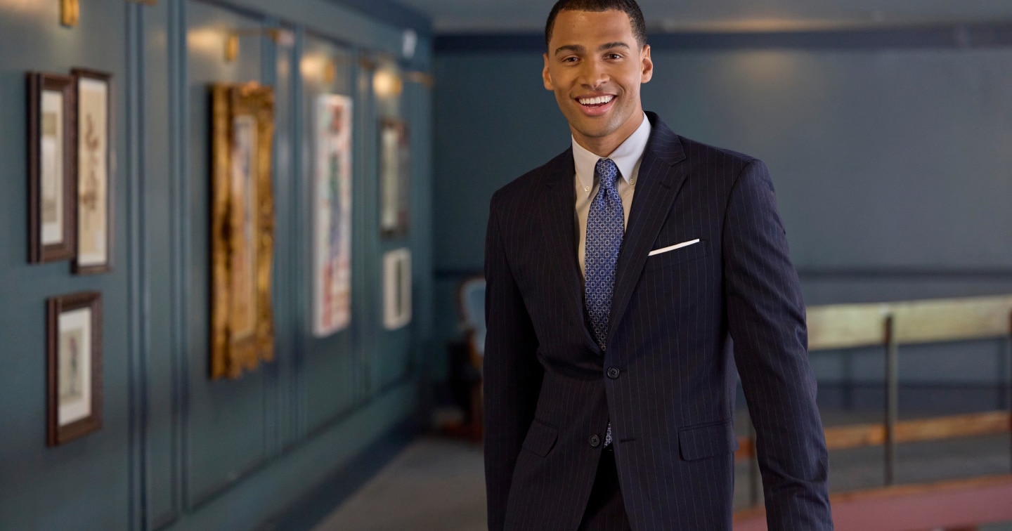 Man wearing a navy pinstripe suit