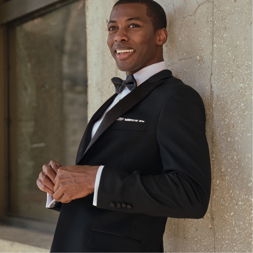 Man wearing a black Traveler tuxedo