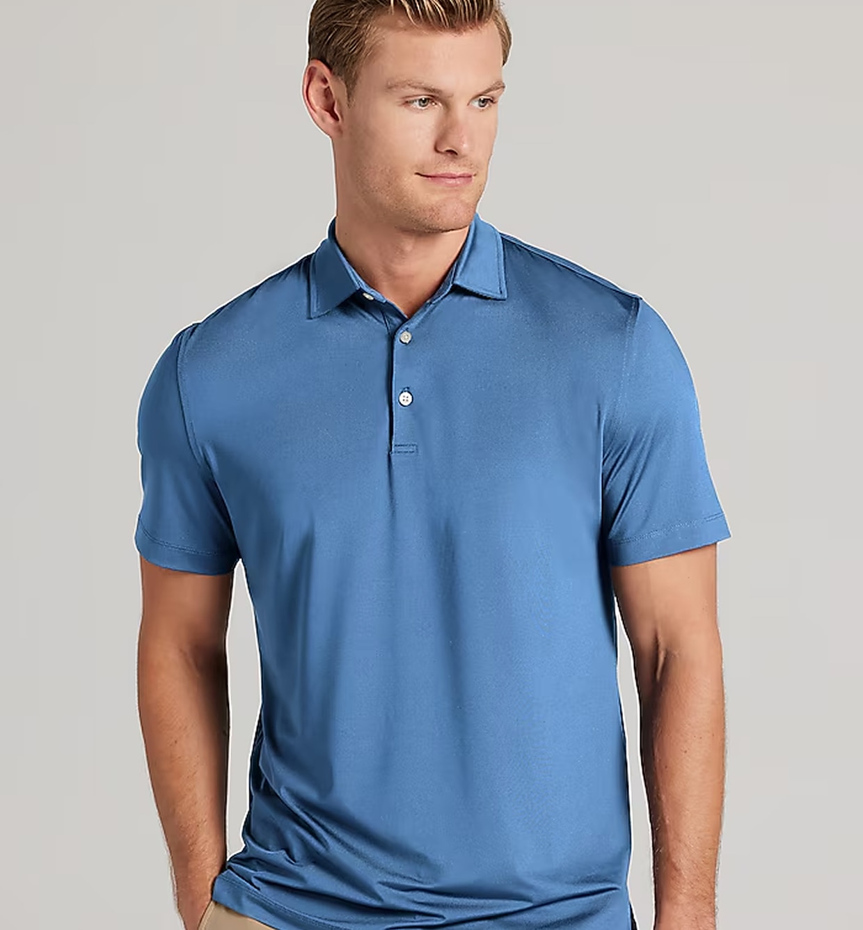 Man wearing a blue Traveler performance polo