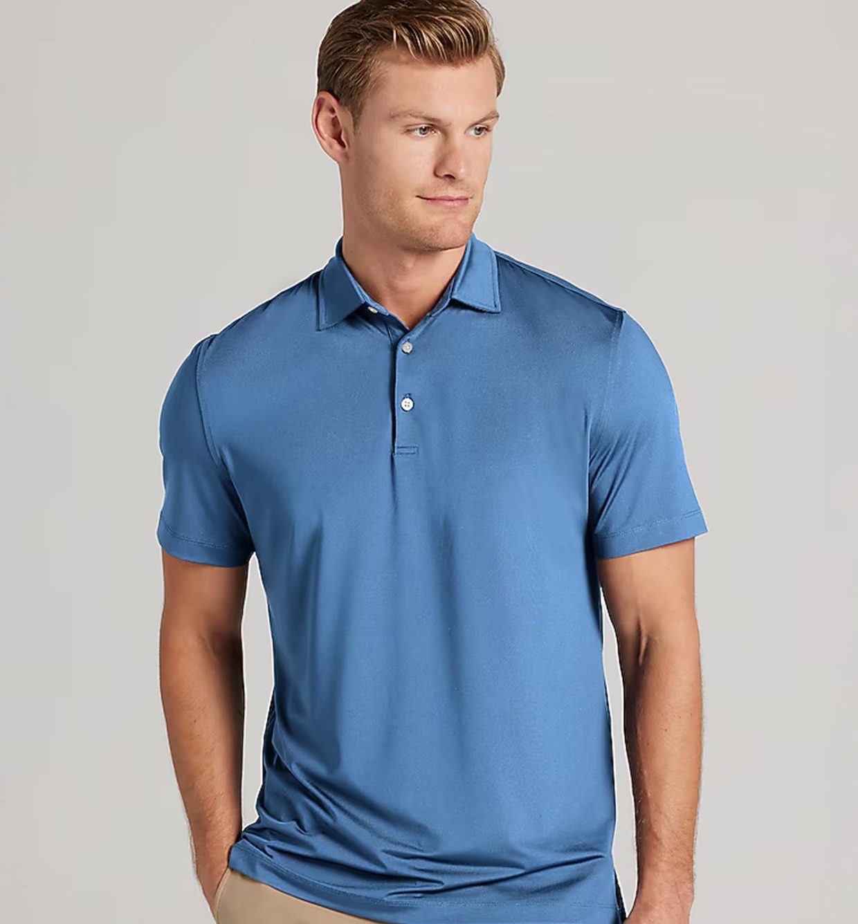 Man wearing a blue Traveler performance polo