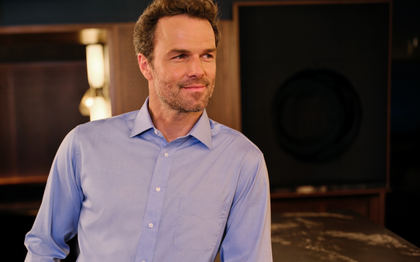 Man wearing a blue Traveler dress shirt
