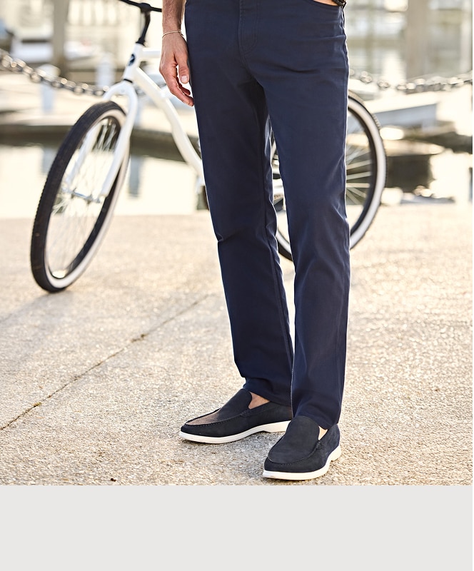 Man wearing navy pants and loafers.