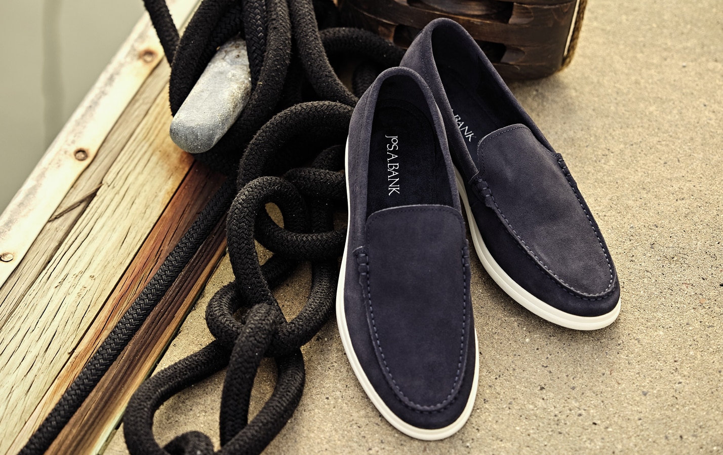Navy suede loafers with white soles