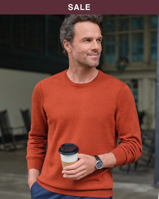 Man wearing an orange crewneck sweater